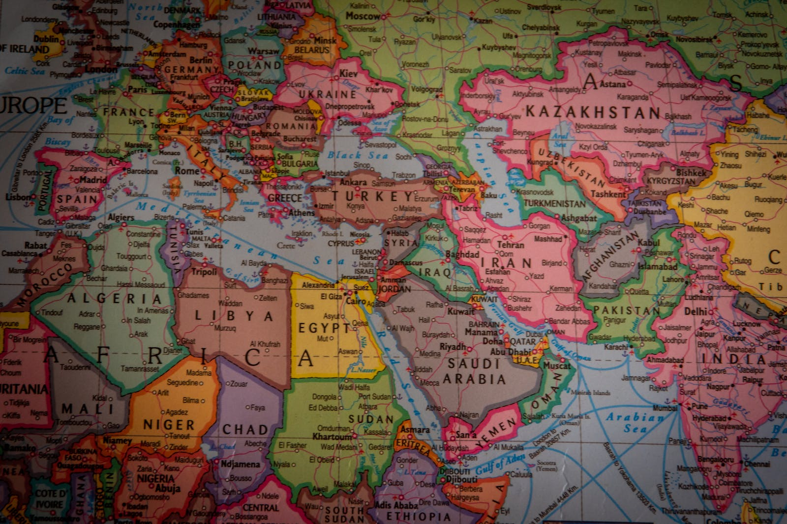 Global world map highlighting high-risk jurisdictions like OFAC sanctioned countries in red, blocked by DEX geofencing tools for crypto compliance